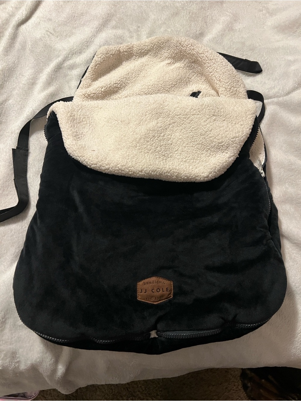 JJ Cole Black seat footmuff with Brown Leather Logo Patch